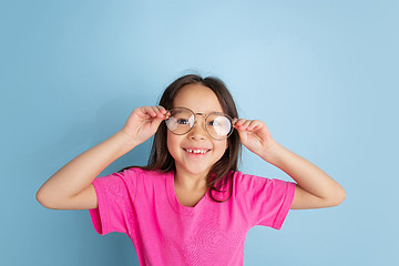 Image showing Caucasian little girl\'s portrait on blue studio background