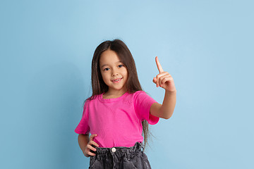 Image showing Caucasian little girl\'s portrait on blue studio background