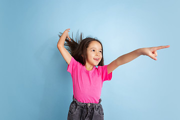 Image showing Caucasian little girl\'s portrait on blue studio background