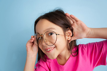 Image showing Caucasian little girl\'s portrait on blue studio background