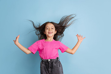 Image showing Caucasian little girl\'s portrait on blue studio background