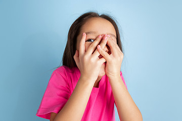 Image showing Caucasian little girl\'s portrait on blue studio background