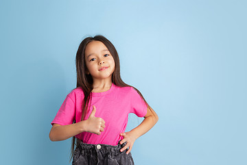 Image showing Caucasian little girl\'s portrait on blue studio background