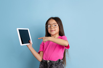 Image showing Caucasian little girl\'s portrait on blue studio background