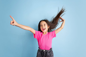 Image showing Caucasian little girl\'s portrait on blue studio background