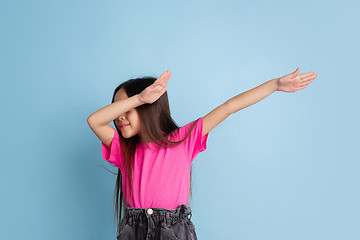 Image showing Caucasian little girl\'s portrait on blue studio background