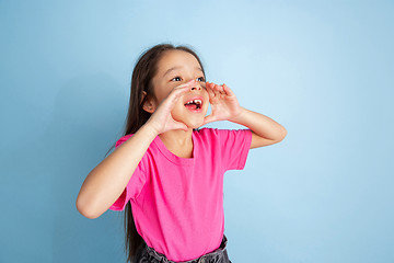 Image showing Caucasian little girl\'s portrait on blue studio background