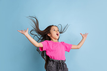 Image showing Caucasian little girl\'s portrait on blue studio background