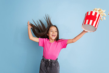 Image showing Caucasian little girl\'s portrait on blue studio background