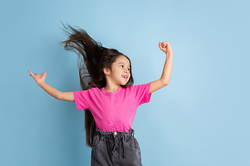 Image showing Caucasian little girl\'s portrait on blue studio background