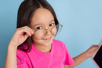 Image showing Caucasian little girl\'s portrait on blue studio background