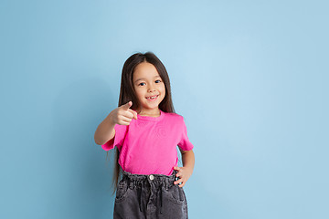 Image showing Caucasian little girl\'s portrait on blue studio background