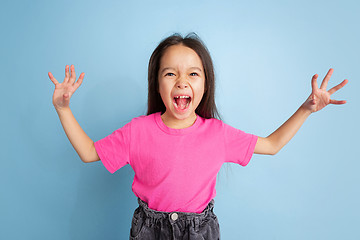 Image showing Caucasian little girl\'s portrait on blue studio background