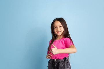 Image showing Caucasian little girl\'s portrait on blue studio background