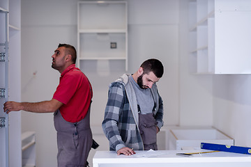 Image showing workers installing a new kitchen