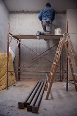 Image showing construction worker plastering on gypsum ceiling