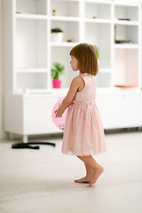 Image showing cute little girl playing with balloons