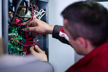 Image showing electrician engineer working with electric cable wires