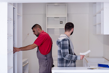 Image showing workers installing a new kitchen