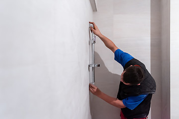 Image showing professional plumber working in a bathroom