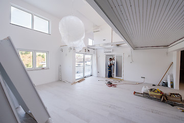 Image showing carpenters installing glass door with a wooden frame