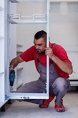 Image showing worker installing a new kitchen