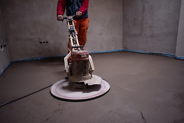 Image showing worker performing and polishing sand and cement screed floor