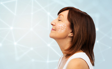 Image showing senior woman with low poly grid on her cheek