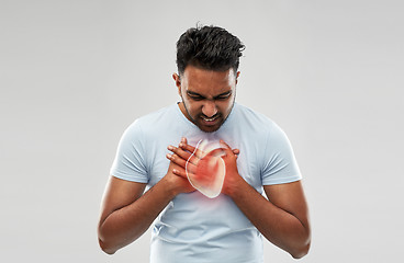 Image showing unhappy man having heart attack or heartache