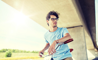 Image showing young hipster man riding fixed gear bike