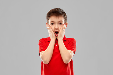 Image showing shocked little boy in red t-shirt touching face