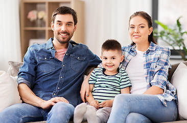 Image showing portrait of happy family sitting on sofa at home