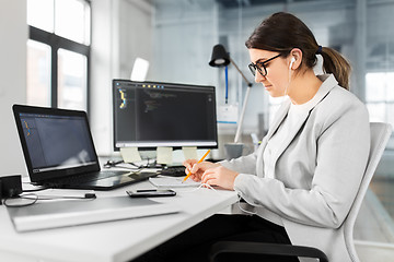 Image showing businesswoman with notebook working at office
