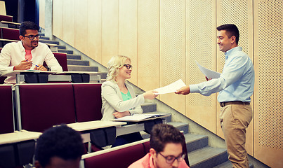 Image showing teacher giving tests to students at lecture