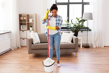 Image showing african woman or housewife cleaning floor at home