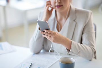 Image showing businesswoman with earphones and smartphone