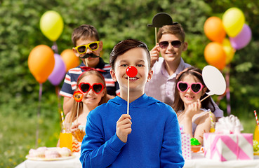 Image showing happy boy with red clown nose at birthday party