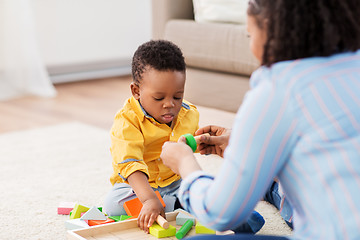 Image showing mother and baby playing with toy blocks at home