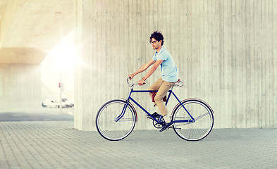 Image showing young hipster man riding fixed gear bike