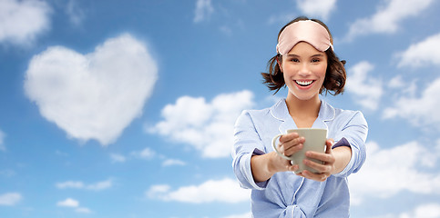 Image showing woman in pajama and sleeping mask drinking coffee