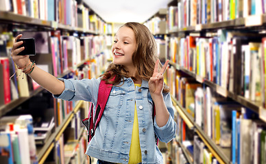 Image showing teenage student girl taking selfie by smartphone