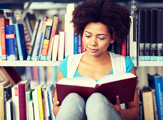 Image showing african student girl reading book at library