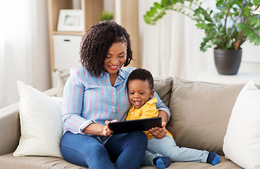 Image showing mother using tablet pc with baby son at home