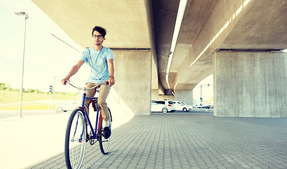 Image showing young hipster man riding fixed gear bike