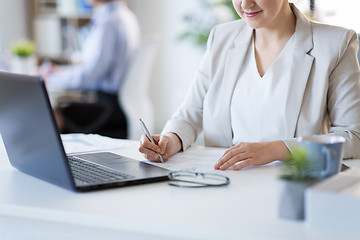 Image showing businesswoman with papers working at office