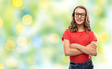 Image showing smiling student girl in glasses over green lights