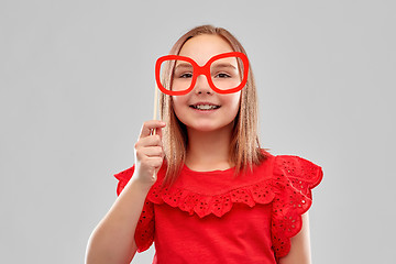 Image showing beautiful smiling girl with big paper glasses