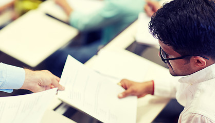 Image showing teacher giving exam test to student at lecture