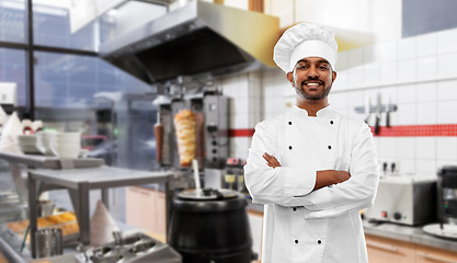 Image showing happy male indian chef in toque at kebab shop