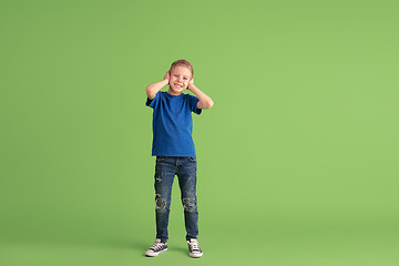 Image showing Happy boy playing and having fun on green studio background, emotions